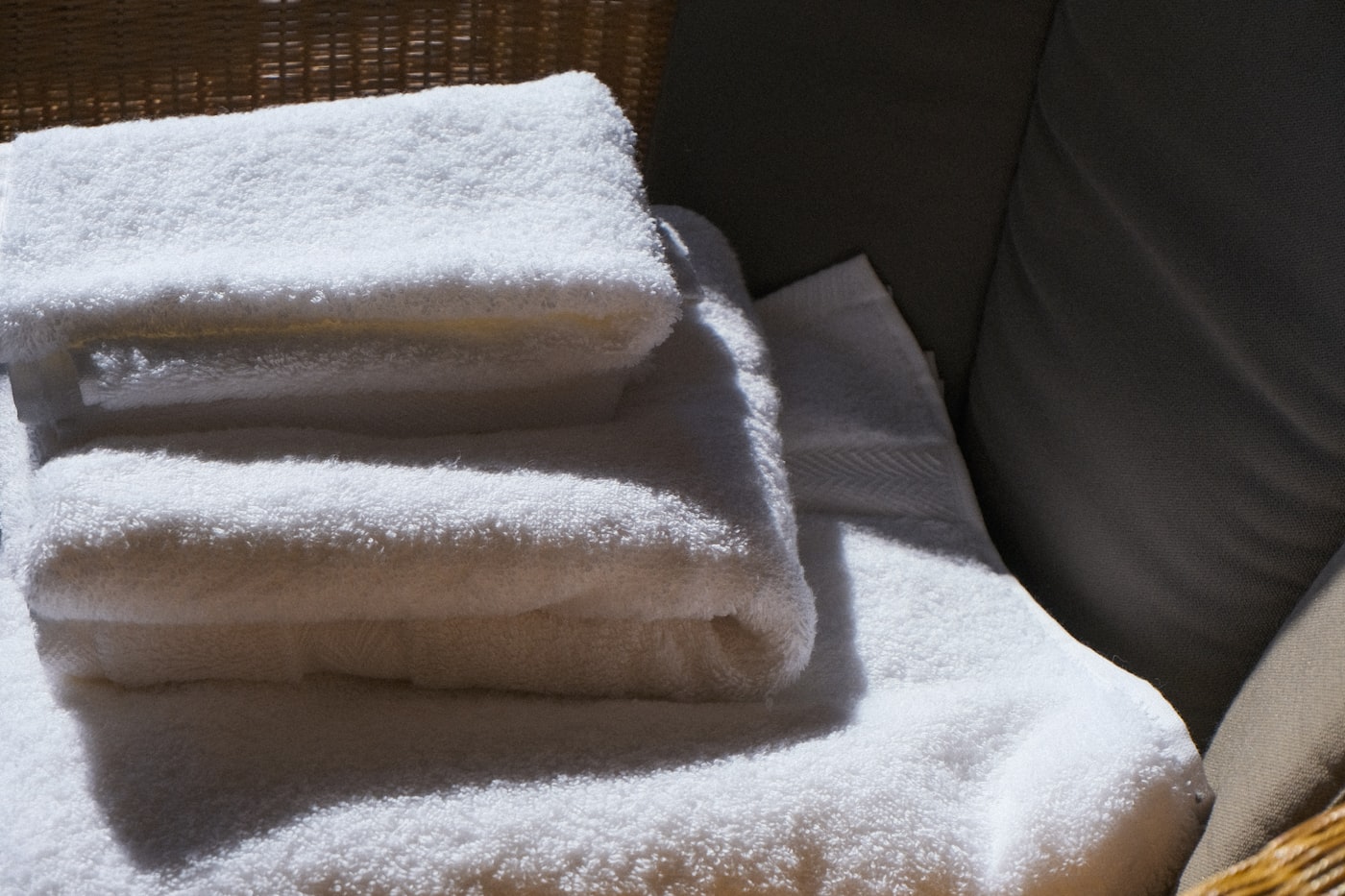 A stack of fresh, hotel-folded towels for the next guest