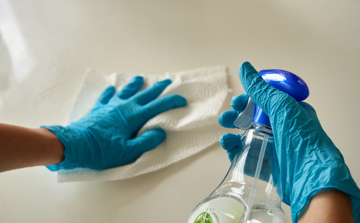 A professional cleaner wiping down a surface