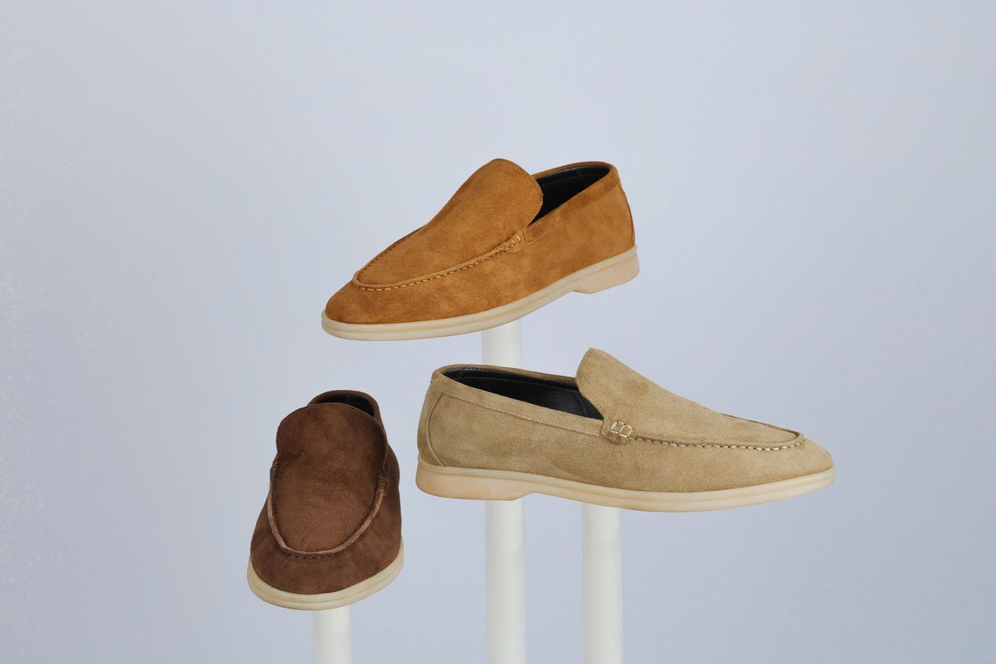 Suede loafers displayed in warm, neutral tones
