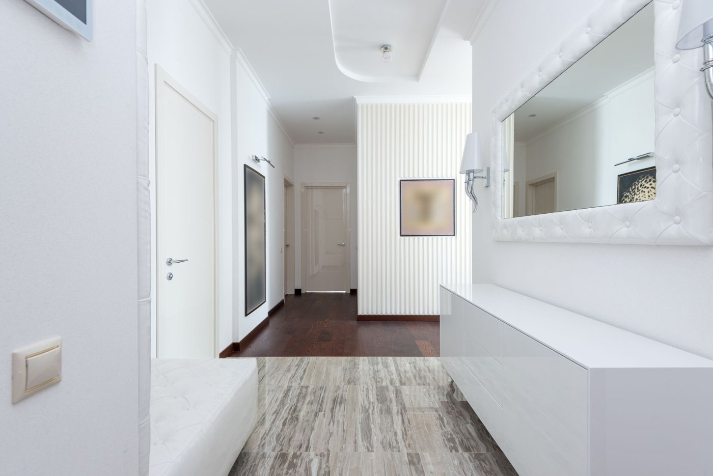 A bright, clean entryway hallway with wood floors